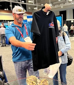 Inland Marine Expo 2026 attendee viewing VMI Dredges promotional merchandise in Nashville, Tennessee