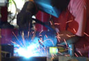 A VMI team member welding